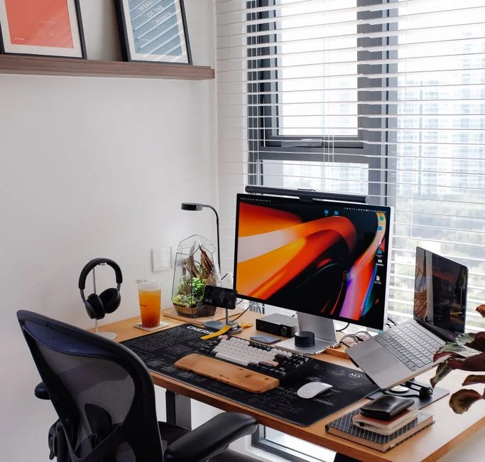 A sleek computer display showing web design projects, highlighting creative visuals in a workspace.